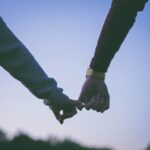 Two hands gently clasped together symbolizing deep connection and mutual respect in high-value relationships