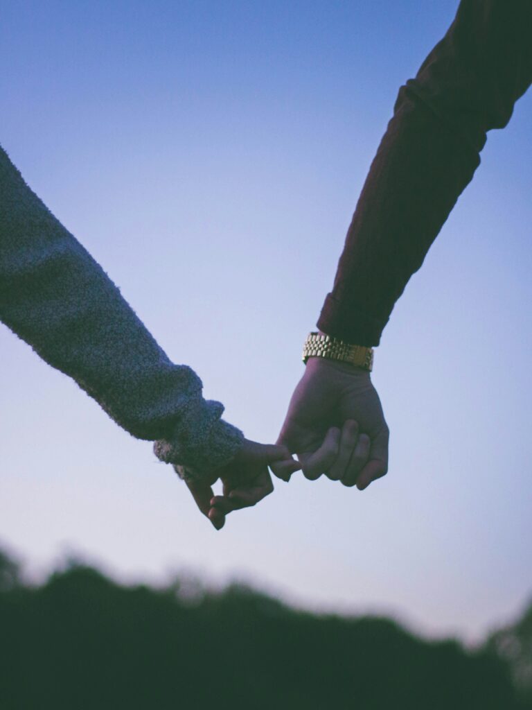Two hands gently clasped together symbolizing deep connection and mutual respect in high-value relationships