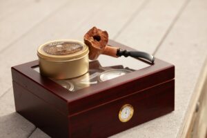 cigar pipe on top of a humidor